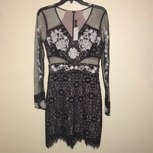 Black & nude dress embroidered with white florals.